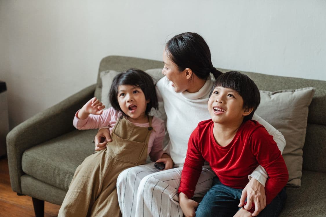 Mother spending time with two children at home